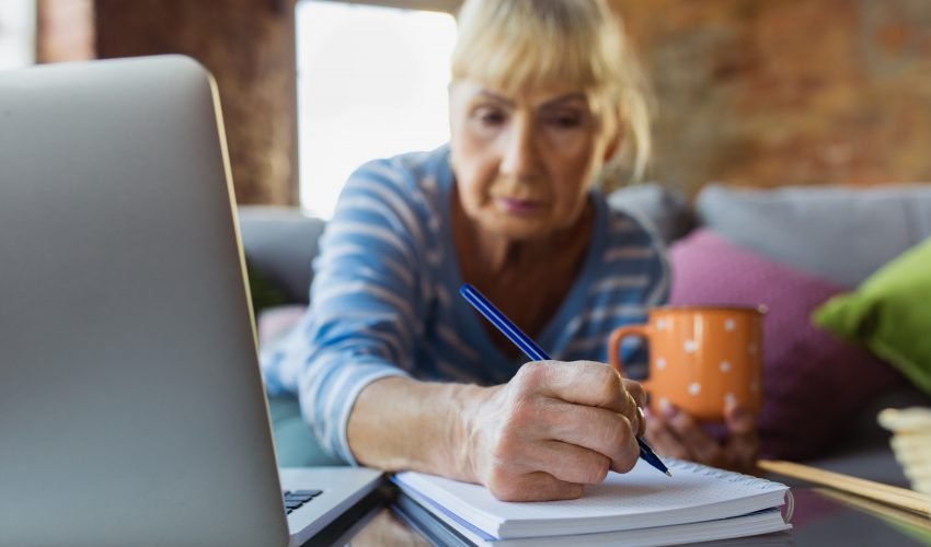 Senior woman studying at home, getting online courses