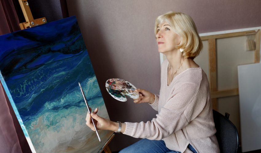 professional-female-artist-painting-on-canvas