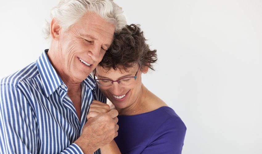 Affectionate senior couple embracing and dancing
