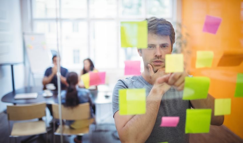 Close-up of male executive reading sticky notes