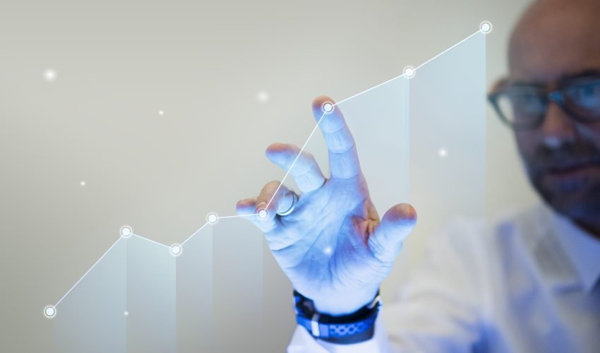 Businessman pointing his finger to a growth graph