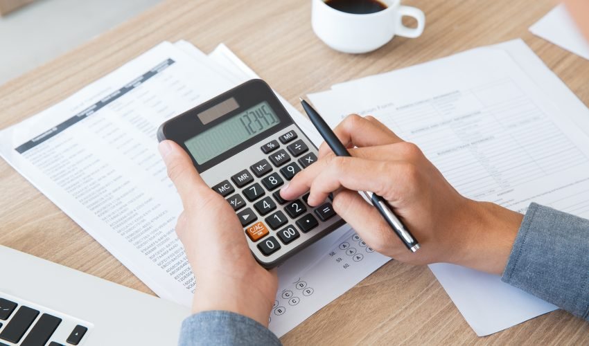 Man using calculator to count income and outcome