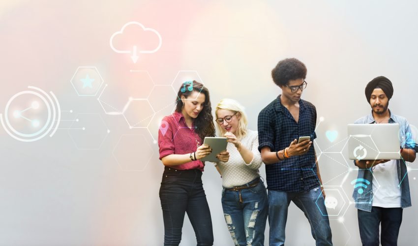 Diverse friends using digital devices