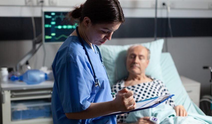 Medical assistant checking treatment of senior man
