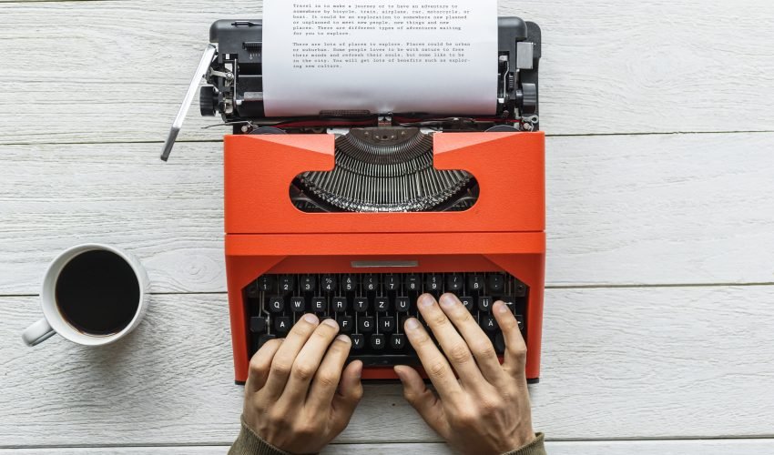 Aerial view of a man typing on a retro typewriter