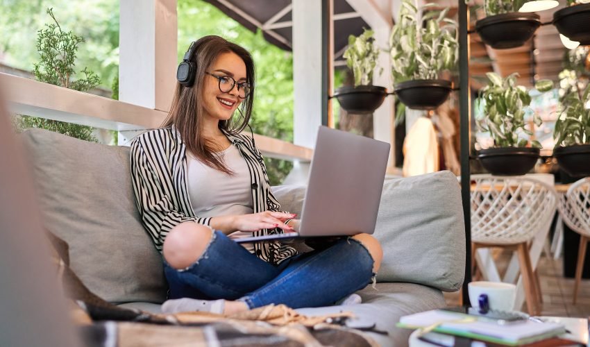 Beautiful student girl learning at home with laptop